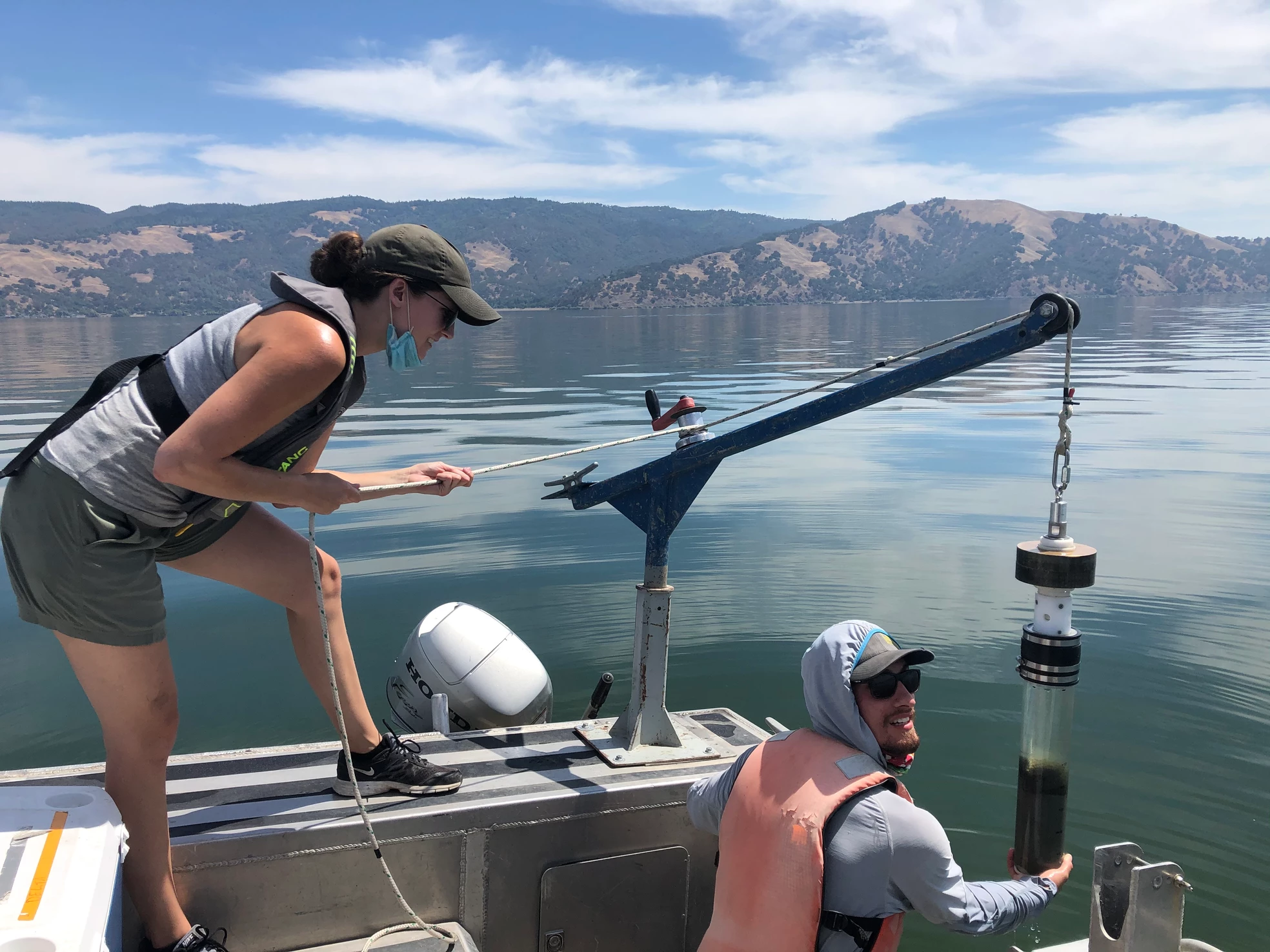 Scientists on a boat hauling up sediment cores